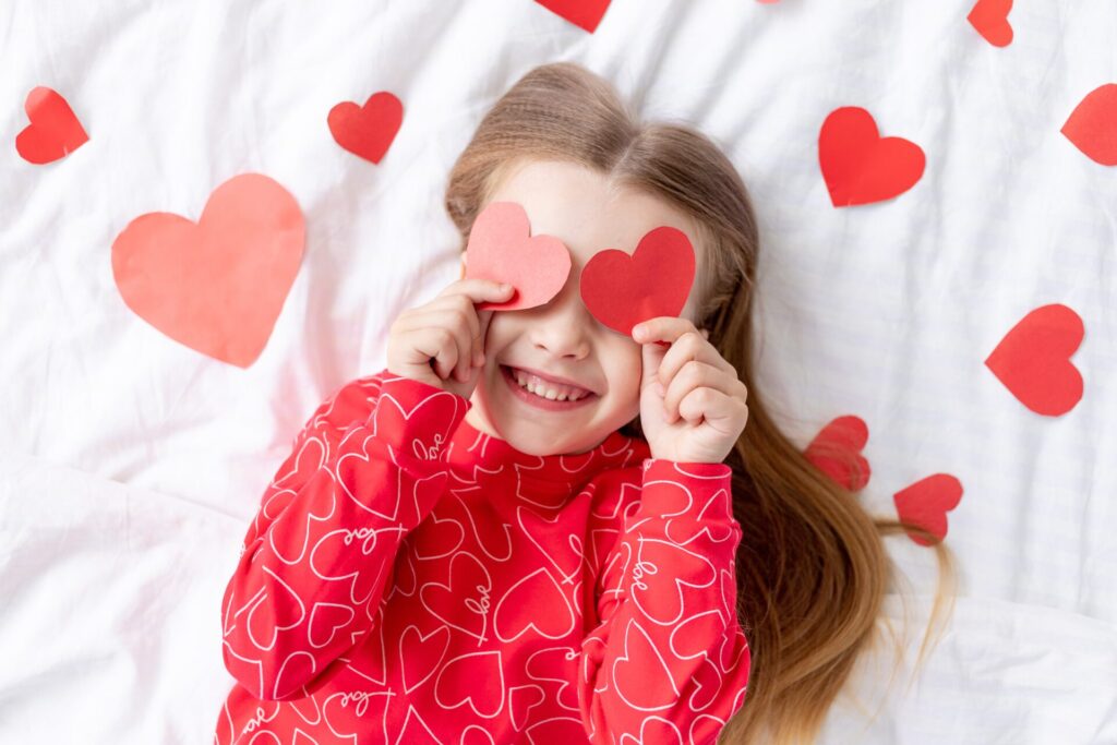 A child with hearts over her eyes