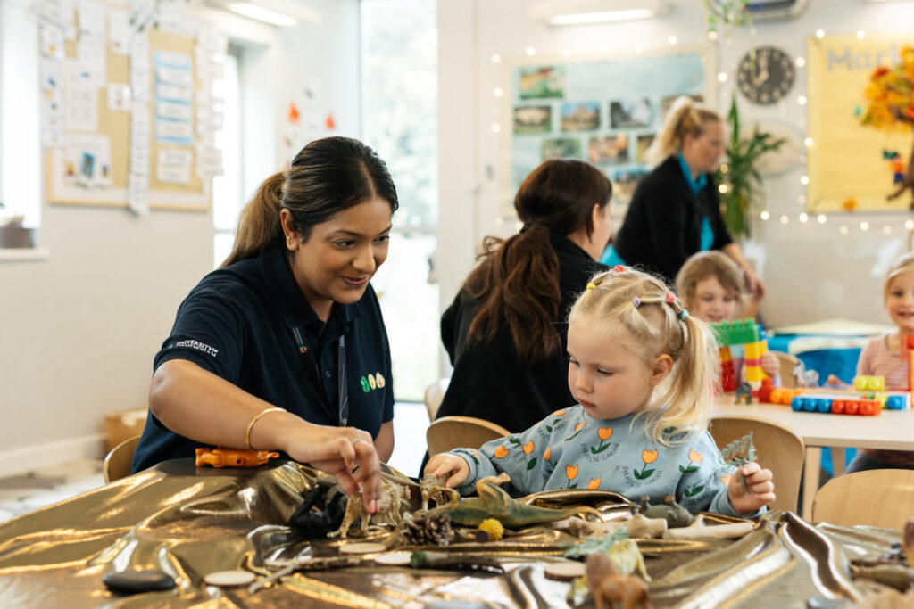 A child with a member of staff