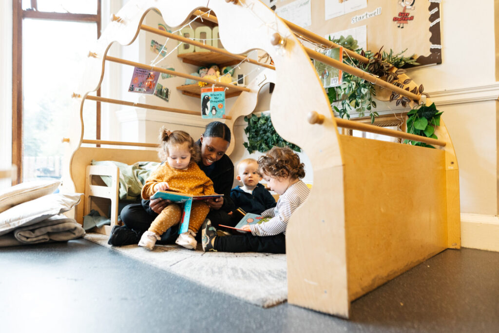 Children being read to in the nursery